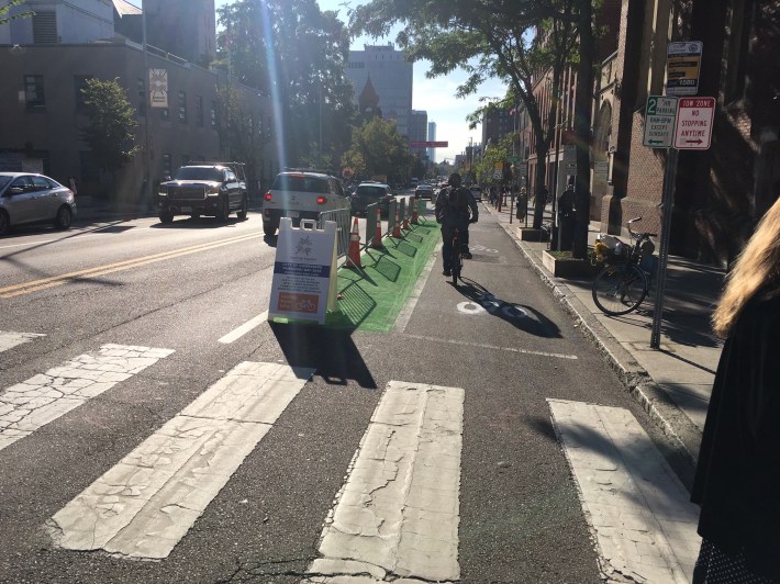 Cambridge Bicycle Safety took over a block's worth of parking spaces to establish a "bike lane-protected" bike lane on the eastbound side of Massachusetts Avenue near Central Square for Park(ing) Day 2019.