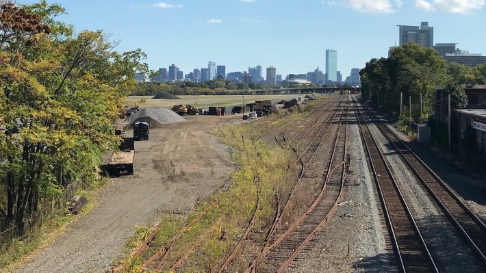 The site of the future West Station, seen from the Cambridge Street overpass in Allston. A realignment of the Massachusetts Turnpike through this area is poised to touch off a massive urban development scheme on the vacant Harvard-owned lands visible in the distance.