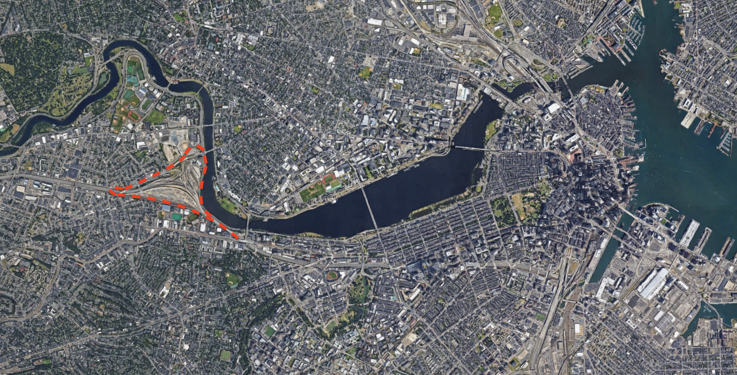 MassDOT's "Allston Intermodal Project," outlined in the red dashed line, covers roughly 90 acres on the Charles River waterfront, from Cambridge Street in the northwest, to the Framingham/Worcester commuter rail tracks to the south, to the Boston University Bridge to the east.