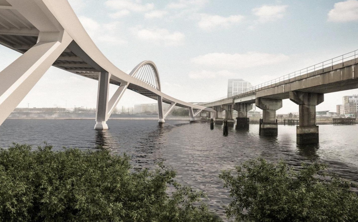 An architect's rendering shows two bridges crossing a river. The illustration of the new bridge, on the right, shows a bridge with large arches swooping over the water. The illustration is superimposed on a photograph that shows an existing, plainer railroad bridge on the right.