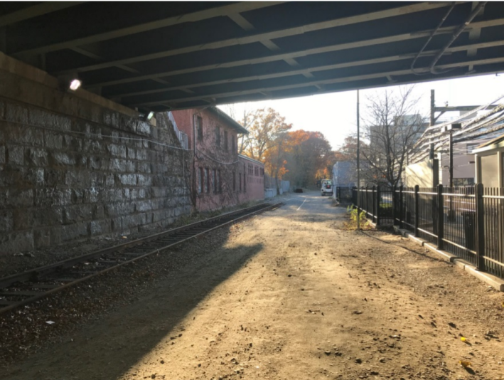 The City of Boston and MassDOT would like to build a new multi-use path connection in this MBTA-owned land under the Park Drive viaduct. The Fenway Green Line station is to the right, and the Muddy River path to the Longwood area and Jamaica Plain is in the distance. Courtesy of MassDOT.