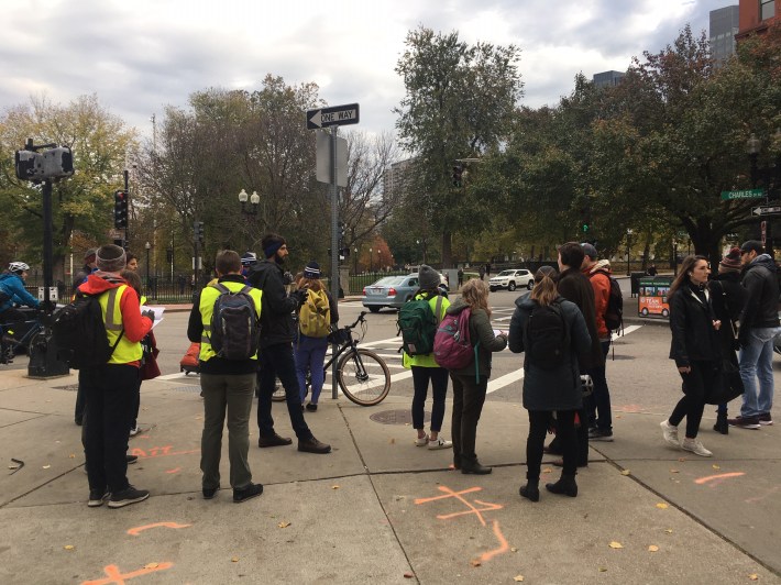 Planners and members of the public discuss bike and walking routes at the corner of Charles and Boylston Streets next to the Boston Common in a community walk on November 7, 2019. This intersection and others around the Common and Public Garden are being considered for upgraded crosswalks and bike routes in the city's Southwest Corridor Extension planning project.
