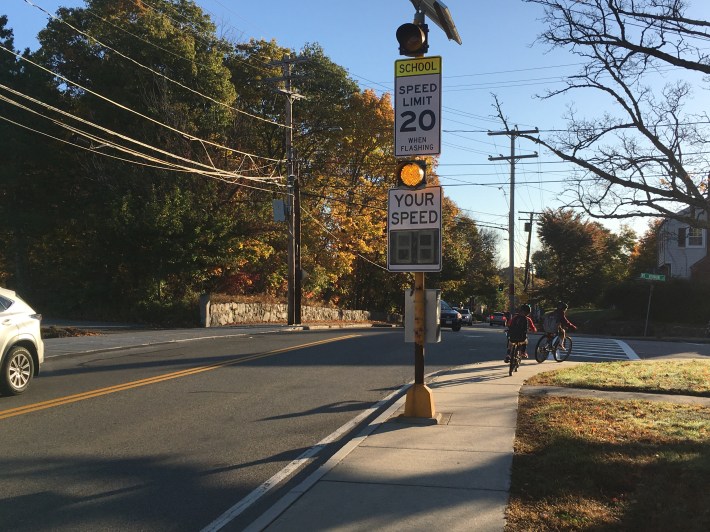 Kids bike to school along High Street in Dedham in October 2019. Car crashes injured at least 6 people on High Street and Whiting Avenue adjacent to the town's schools in 2019.