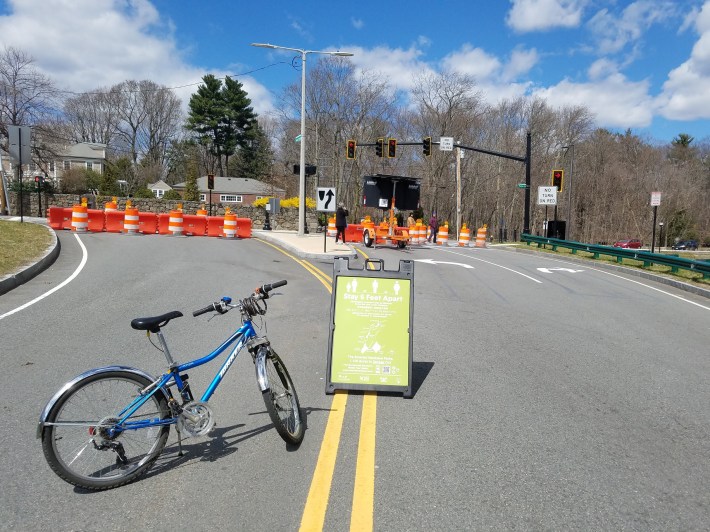 Construction barrels block cars and a sign encourages park users to stay 6 feet apart on Parkman Drive next to Jamaica Pond on April 11, 2020. Photo courtesy of Sarah Freeman.