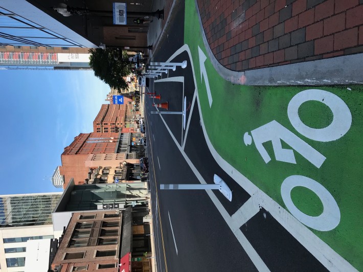 New parking-protected bike lanes have been installed on a short section of Stuart Street in downtown Boston between Charles Street and Washington Street, as seen in this July 7, 2020 photo.