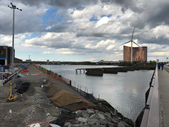 This Oct. 1, 2020 photo shows the new riverbank pathway being built along the Mystic River as part of a riverbank stabilization project next to the MBTA's Charlestown bus garage (visible at the left edge of this photo). The new path will connect the Alford Street Bridge to Draw Seven Park near Assembly Square in Somerville.