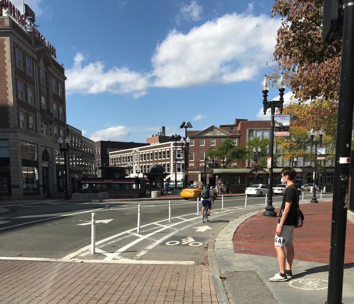 The newly widened bike lane with flexible post bollards on Massachusetts Avenue in Harvard Square. The City of Cambridge implemented the new layout after a truck driver struck and killed Darryl Willis while he was riding in the previous bike lane, which lacked any physical protection, earlier this summer.