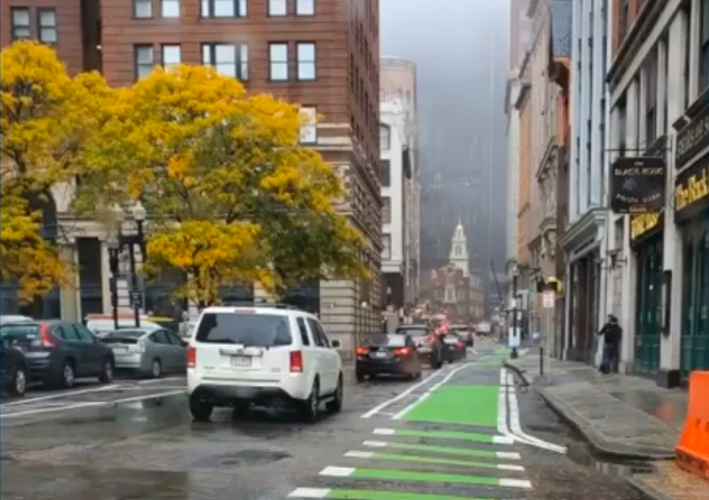 A quick-build protected bike lane on State Street in downtown Boston, pictured in October 2020. Courtesy of the City of Boston.