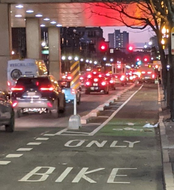 A view of the former curb-protected bike lane on Massachusetts Avenue through the Boston Medical Center campus, pictured before the cast concrete curbs were removed on Wednesday, December 16, 2020. Contributed photo by Wali Sabuhi.