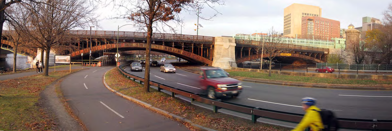 The current configuration of Storrow Drive under Longfellow Bridge occupies most of Boston's esplanade, leaving only a narrow strip for bikes and pedestrians along the riverbank. Photo courtesy of the Esplanade Association.
