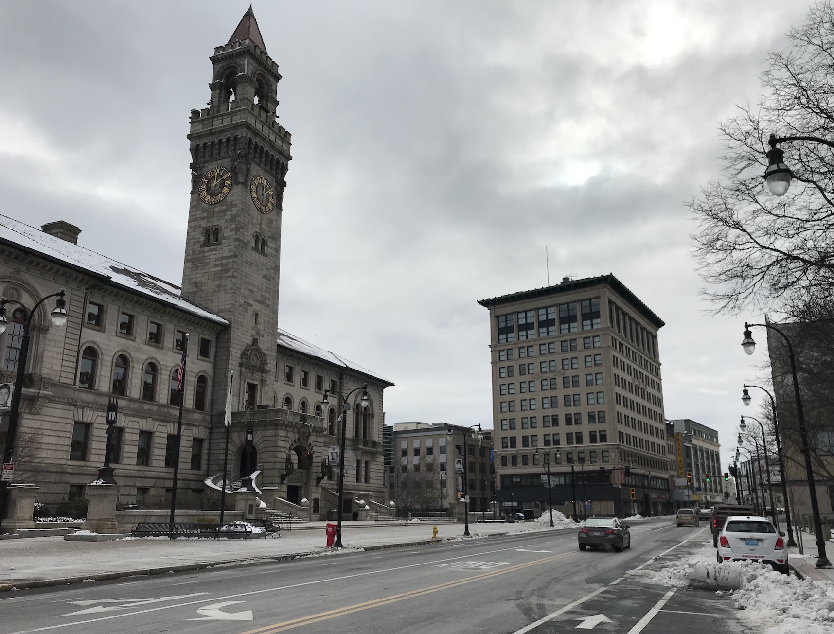 Worcester City Hall, an imposing Italianate building with a tall clock tower, and Worcester's Main Street on a gray December day.