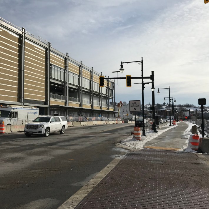 Madison Street, a busy four-lane arterial, gained a new shared-use sidepath (pictured at right) as part of MassDOT's Kelley Square reconstruction project, pictured here in December 2020. At left is the under-construction Polar Park baseball stadium.