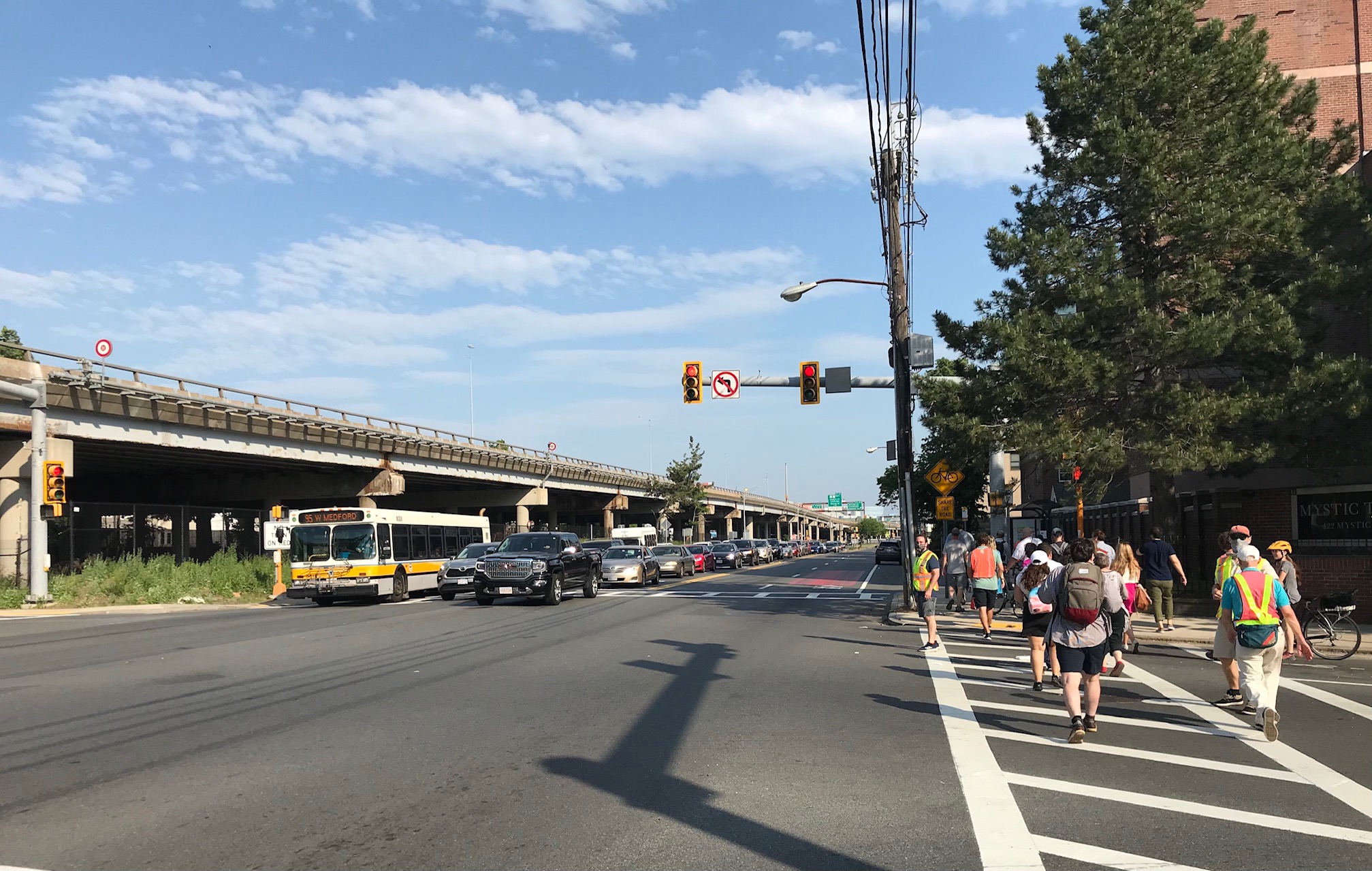 Mystic Ave. in Somerville at the intersection with Temple Street, with the Interstate 93 viaduct at left.