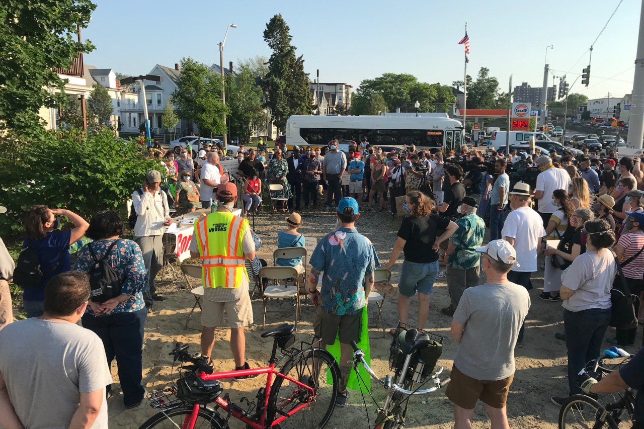 Advocates and elected officials gathered at an abandoned gas station on May 26, 2021 to memorialize victims of traffic violence in the area and demand immediate safety improvements to nearby roadways, including Mystic Ave. and the McGrath Highway.