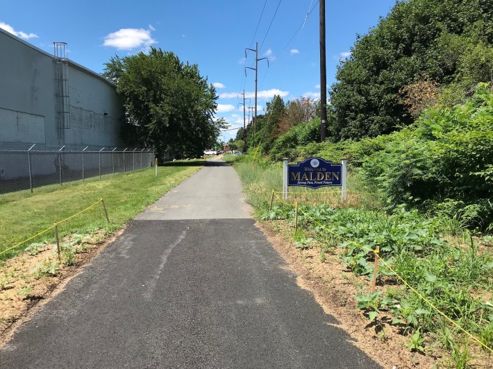 At the edge of Revere, the new asphalt of the Northern Strand path extension project meets the existing path in Malden.