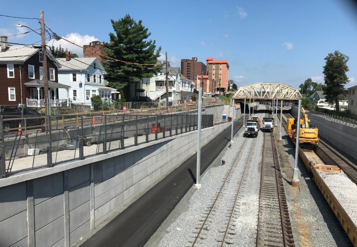 New Green Line tracks and fresh pavement on the future Community Path, pictured from Cross Street in Somerville, looking northwest towards the McGrath Highway, on July 30, 2021.