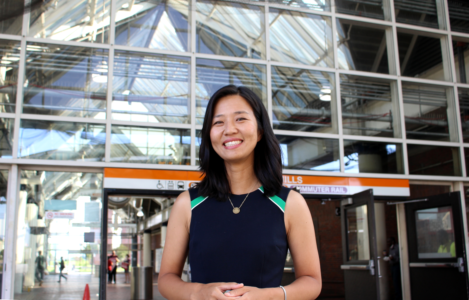 Boston City Councilor and mayoral candidate Michelle Wu in front of the entrance to the Forest Hills T station