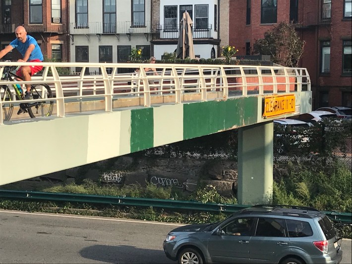 The structural steel on the Fairfield Street pedestrian overpass over Storrow Drive exhibits scratches and dents from frequent crashes caused by over-height trucks.