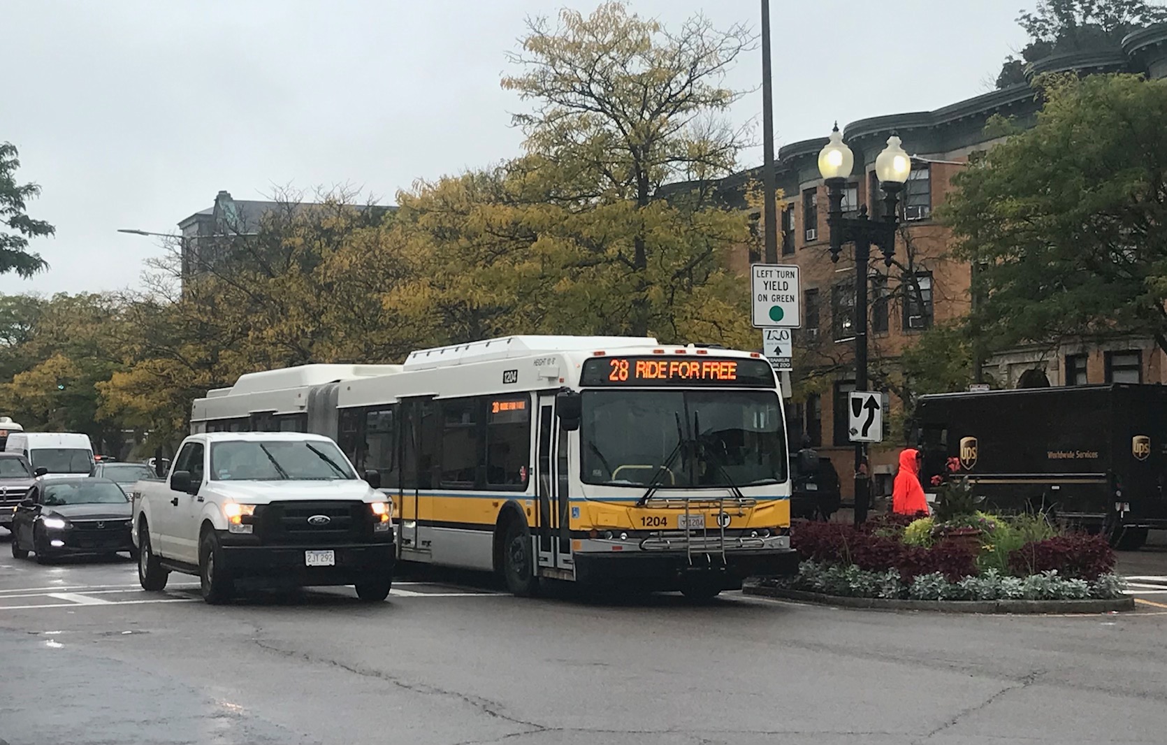 A route 28 bus advertising the fare-free pilot passes through Grove Hall on Blue Hill Avenue on October 5, 2021.A route 28 bus advertising the fare-free pilot passes through Grove Hall on Blue Hill Avenue on October 5, 2021.