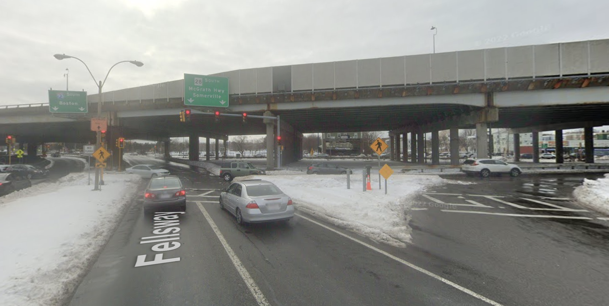 A Google Street View snapshot of the Fellsway in Somerville, showing a snowbank burying the rightmost lane at its intersection with Mystic Avenue.