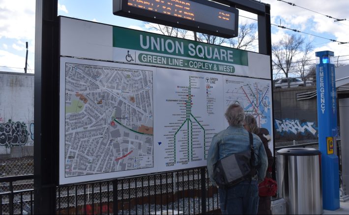 Riders examine the updated MBTA rapid transit maps at the new Union Square station on its opening day, Monday, March 21, 2022.