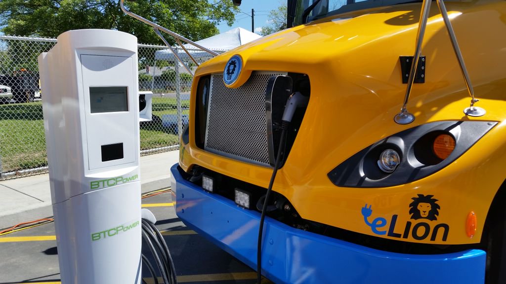 An electric school bus recharges at an electric vehicle charging station in Sacramento.
