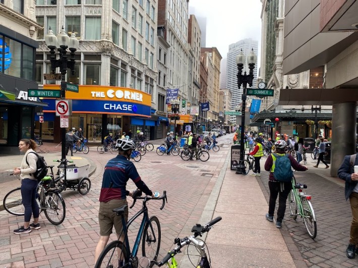a crowd of bikers gathered at downtown crossing for Bike to Work Day celebrations