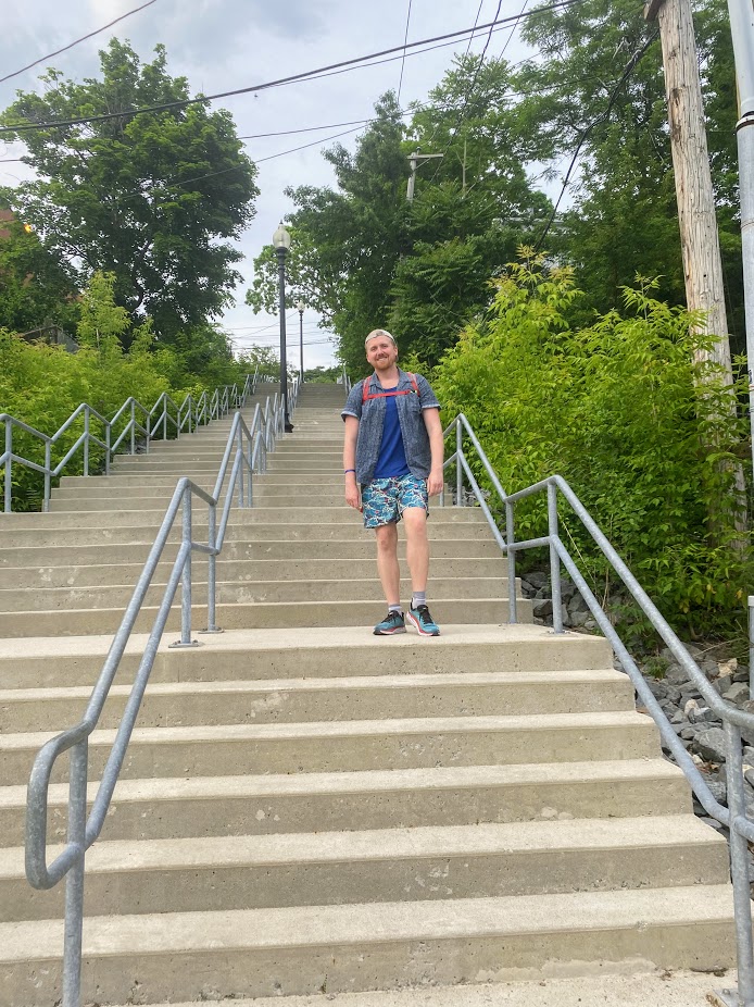 Miles posing near the base of the steep Hayden Street Stairway, which connects Heath Street at the bottom to Lawn Street at the top, near the VA Medical Center. We joked how the number of steps was giving porter square vibes.