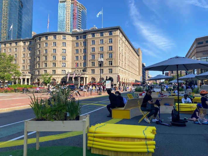 A variety of quick-build seating options occupy the former motor vehicle lanes of Dartmouth Street during the City of Boston's "Copley Connect" pilot.