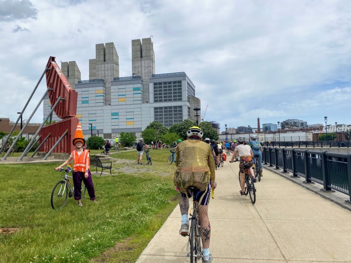 Decked out with a knitted traffic cone hat, a bike marshall guided folks to the rest spot at Rolling Bridge Park- a green space tucked between I-93 and I-90 overlooking Bass River.
