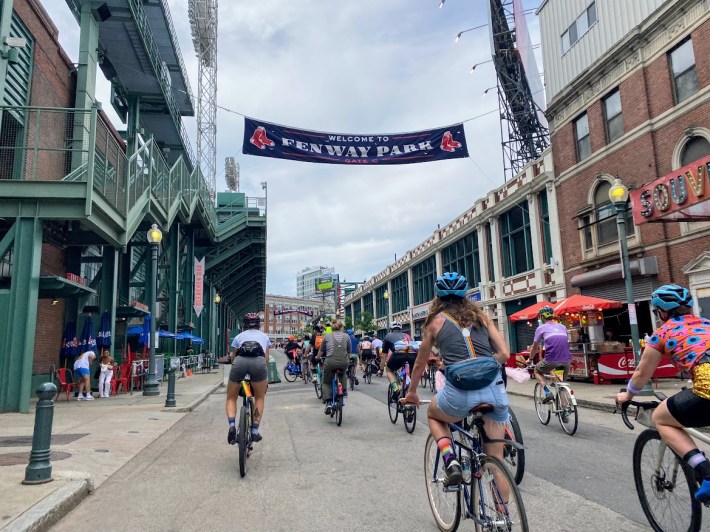 bicyclists rolling down Lansdowne Street into the Fenway Park area as other folks were coming in for Bar Fest.