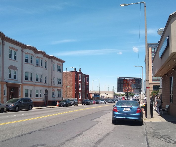 Construction signage has gone up on Massachusetts Avenue near Edward Everett Square in Dorchester for the "Mass. Ave. Better Bikeway" project, which will install a two-way protected bikeway between Columbia Road and Melnea Cass Boulevard. Courtesy of the City of Boston.