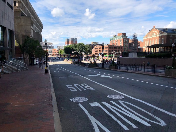 A lane marked "BUS ONLY" runs along the curb of Congress Street next to City Hall (left) and Faneuil Hall (right)