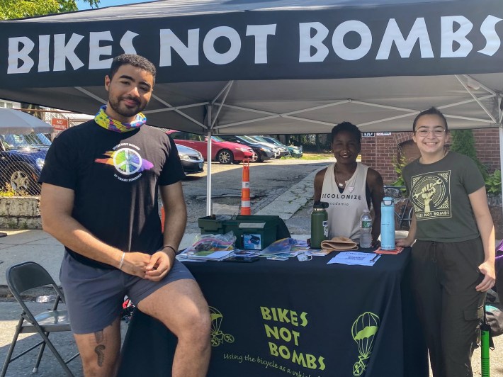 Montell Khaldi, Youth Organizer with Bikes Not Bombs, a local nonprofit who aims to use the bicycle as a vehicle for social change, poses alongside two youth apprentices volunteering at Open Streets Roxbury this past Saturday.