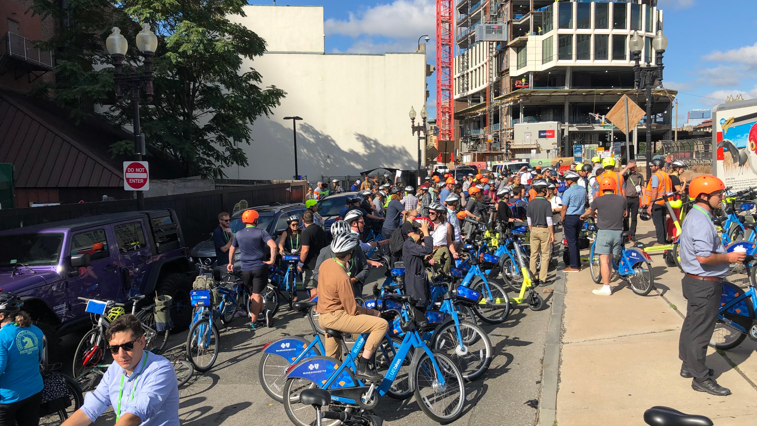 A crowd of people and Bluebikes gathers near Boylston Street
