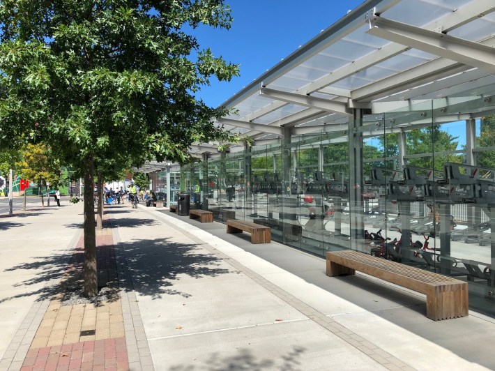 The bike parking buildings at the new Harvard Engineering School complex in Allston. Two glass-clad pavilions next to the Western Avenue protected bike lane have the capacity to park hundreds of bikes for students and employees.