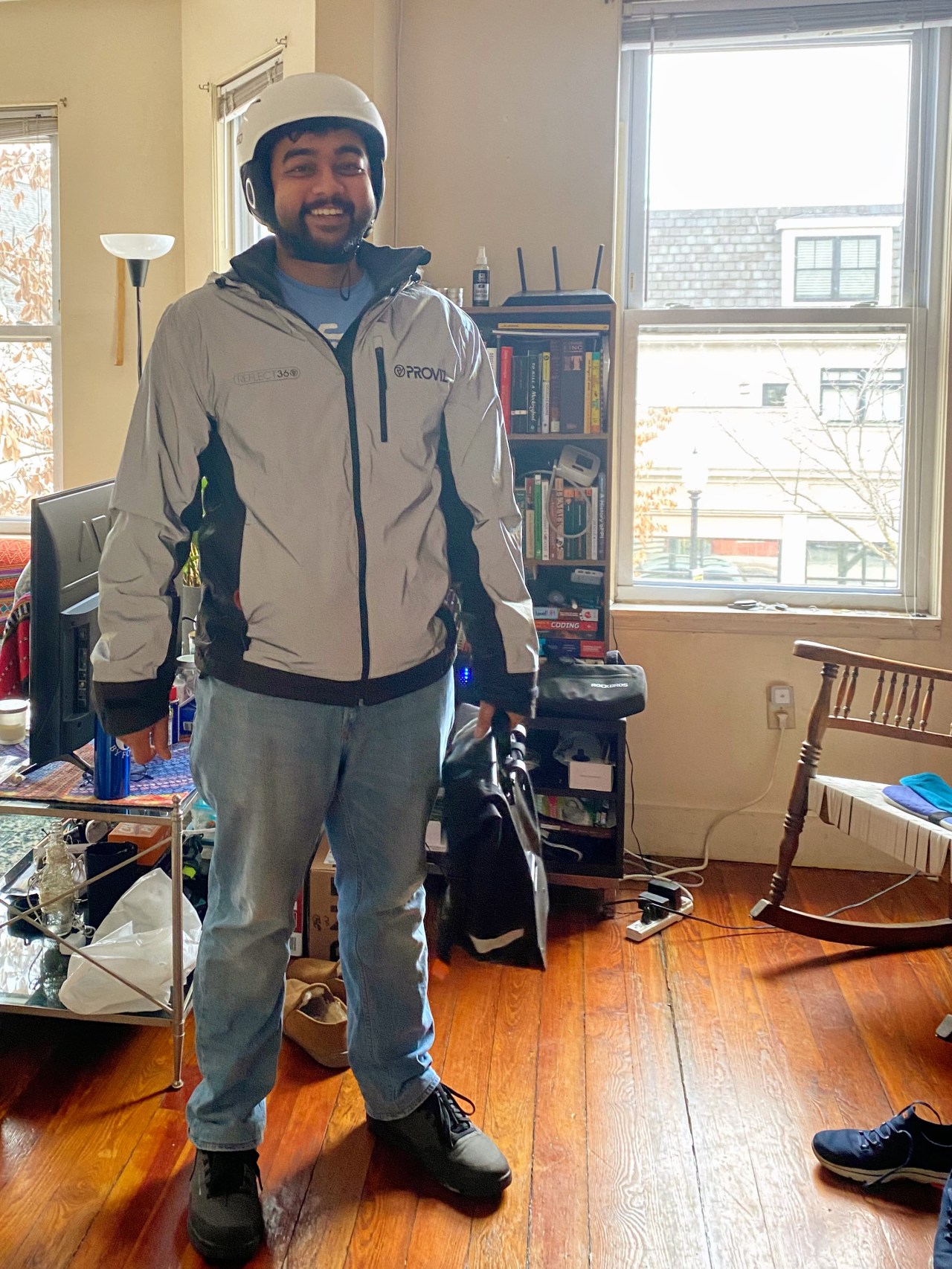 Deodhar poses after putting on his biking gear which includes a helmet with cushioned side flaps to keep his ears warm during the winter, a reflective jacket for visibility and a saddle bar he can hang from the bike’s reach rack.