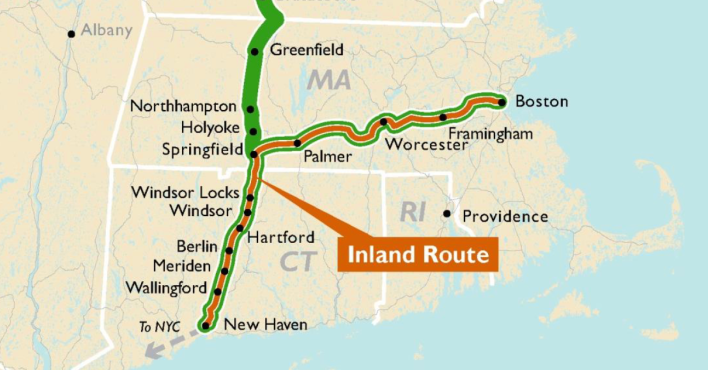 Map of southern New England highlighting a new "Inland Route" passenger rail service, shaped like an upside-down "L", which connects New Haven (near the bottom left on the map) to Harford and Springfield, then bending east to connect to Worcester, Framingham, and Boston (in the center-right portion of the map).