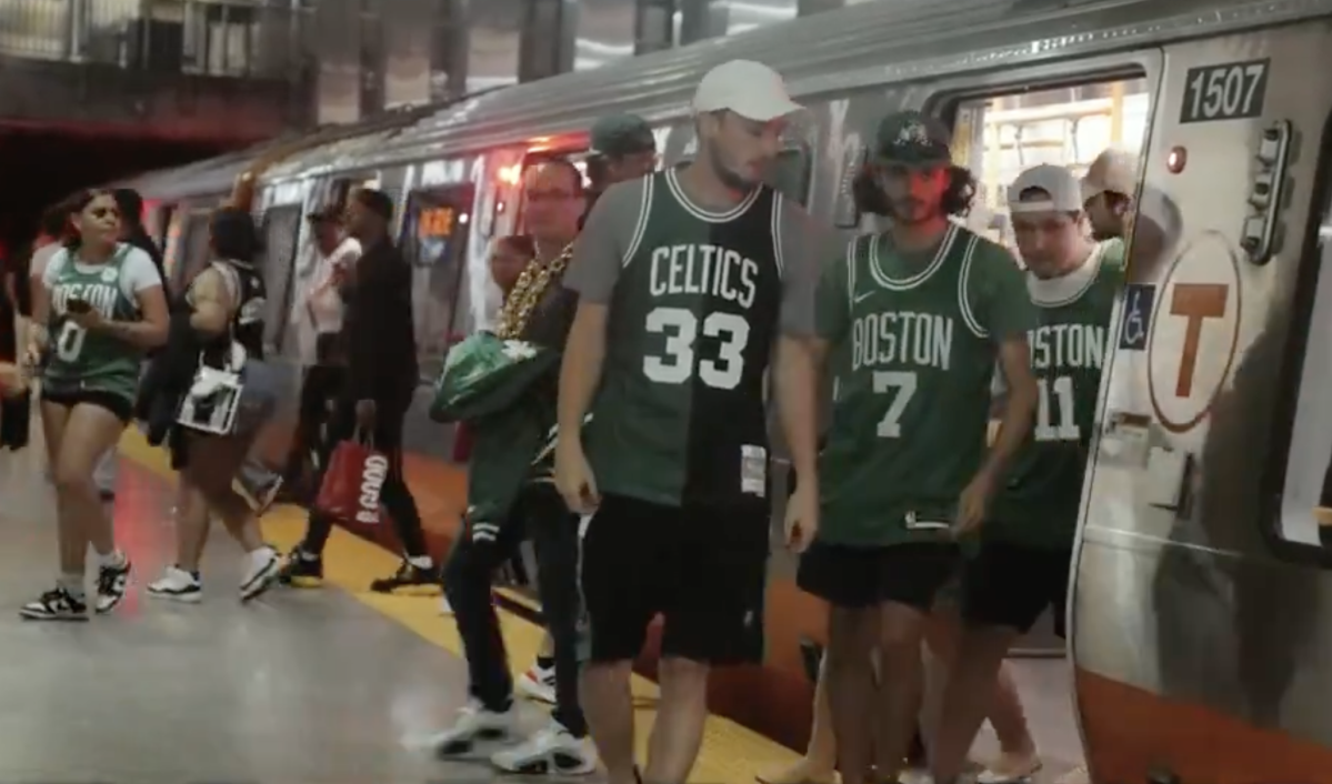 Fans wearing Celtics jerseys disembark from an Orange Line subway train at North Station. Courtesy of the MBTA.