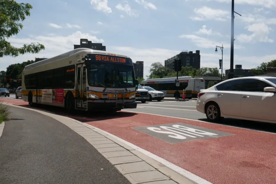 An MBTA 66 bus drives down a red-painted dedicated bus lane.