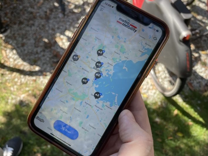 A screenshot of a phone app showing a map of the Boston region with six bike icons scattered around the map.