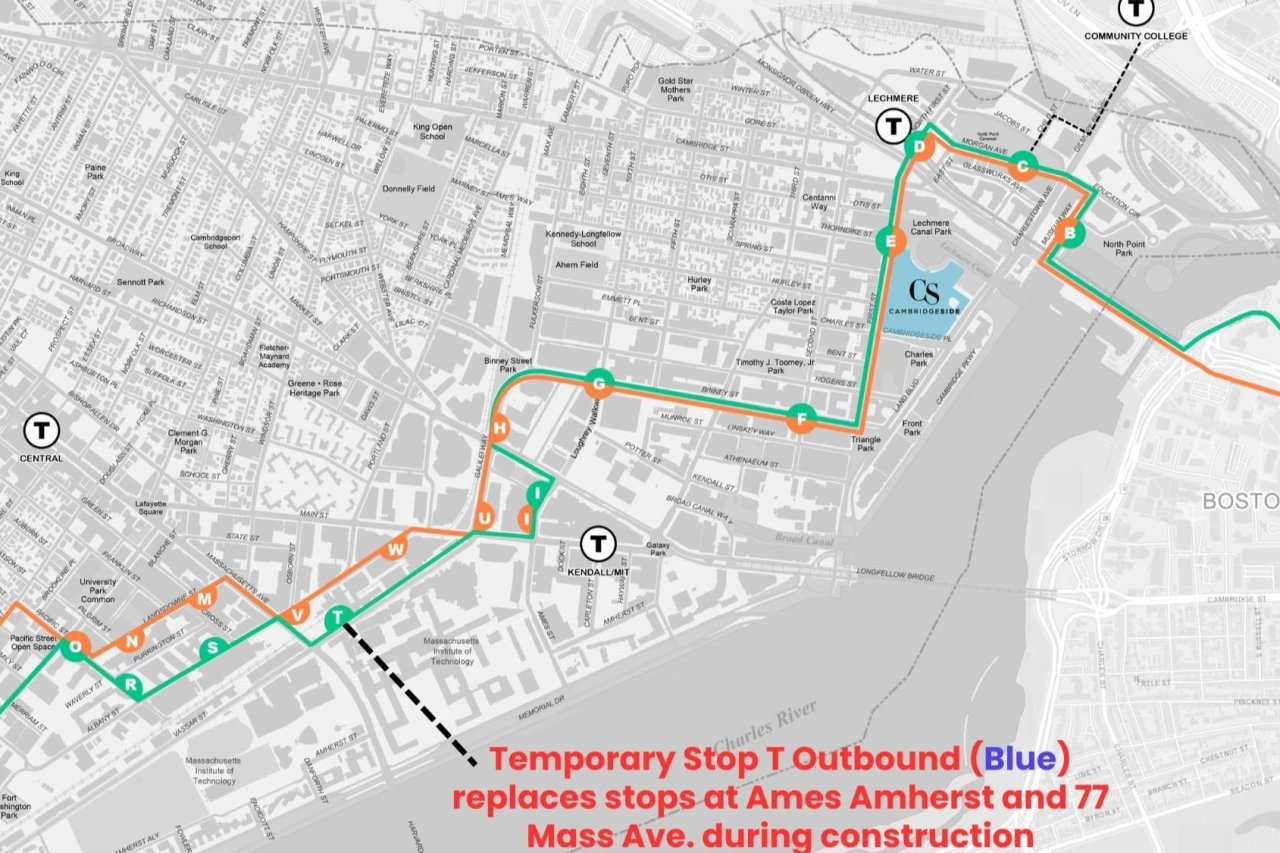 A map of the Kendall Square area of Cambridge, with the Charles River crossing the map from the lower edge to the upper right corner. A green and yellow bus route crosses the map from the lower left to North Station in Boston on the right edge.