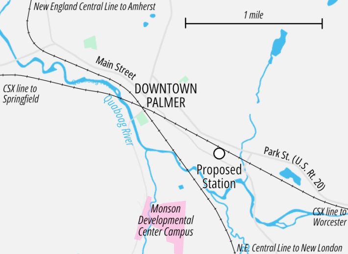 A basic map of Palmer, MA showing the Quaboag River (which meanders as a blue line from the left to lower right), two railroad lines that intersect at an acute angle near downtown Palmer in the center, and a proposed train station location about 1/2 a mile SE of downtown, alongside one of the rail lines. A pink-shaded area on the bottom edge, south of the river and about 1/2 a mile south of downtown Palmer, is labelled "Monson Developmental Center Campus".