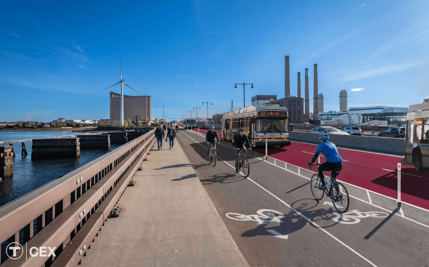 A rendering of the Alford Street Bridge in Boston with a red-painted dedicated busway in the roadway (far right) next to a two-way bike path (center right) and the existing bridge sidewalk (left). In the distance is visible the high-rise Encore Casino.